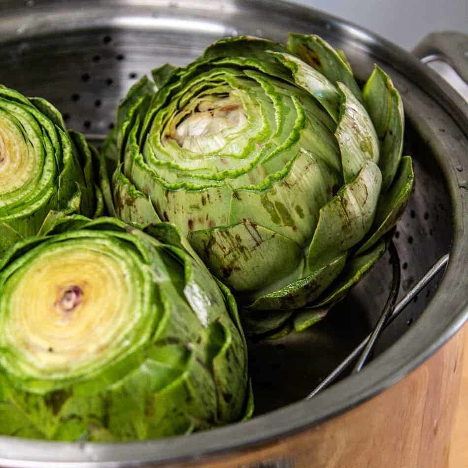 Artichokes in colander prepped and ready to be steamed