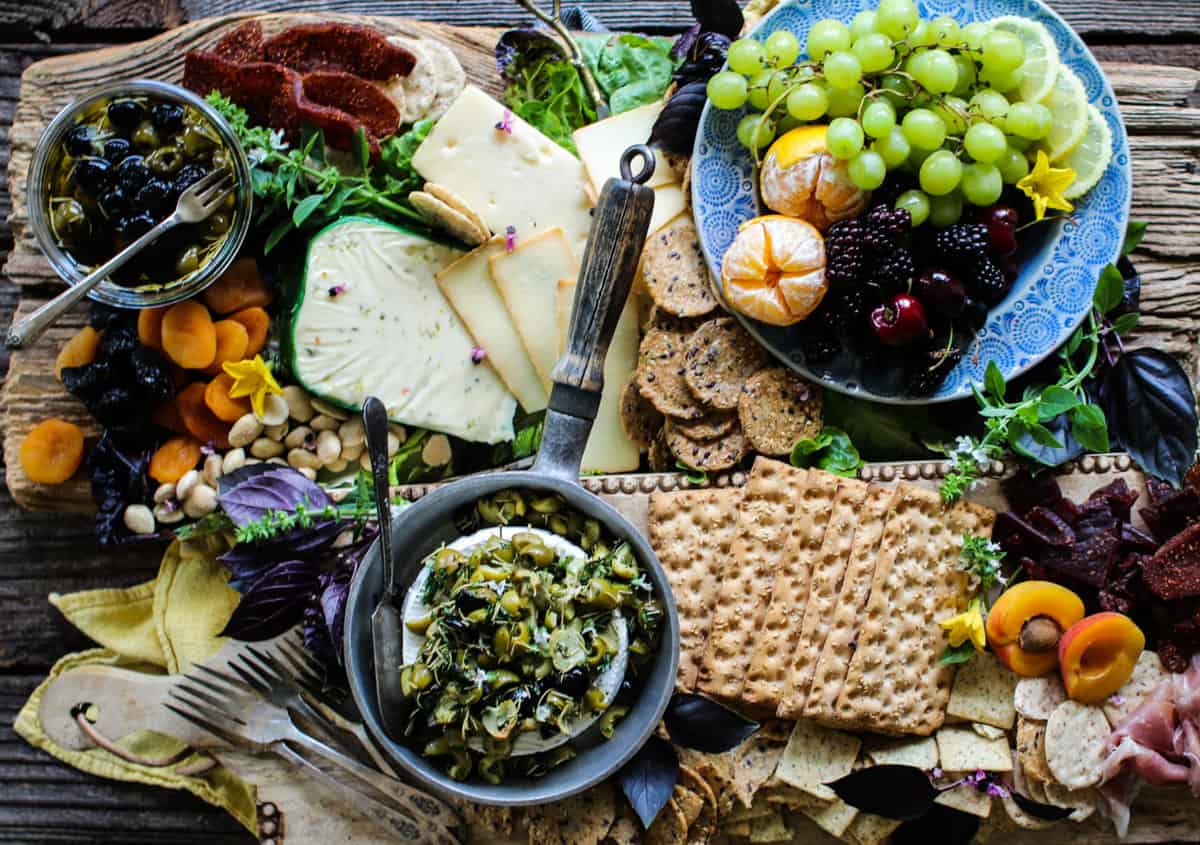 Green and black California ripe olives on a graze board