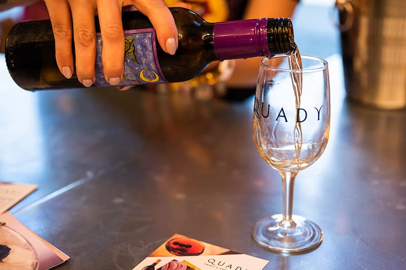 Dessert wine being poured at a tasting at Quady winery in Madera.