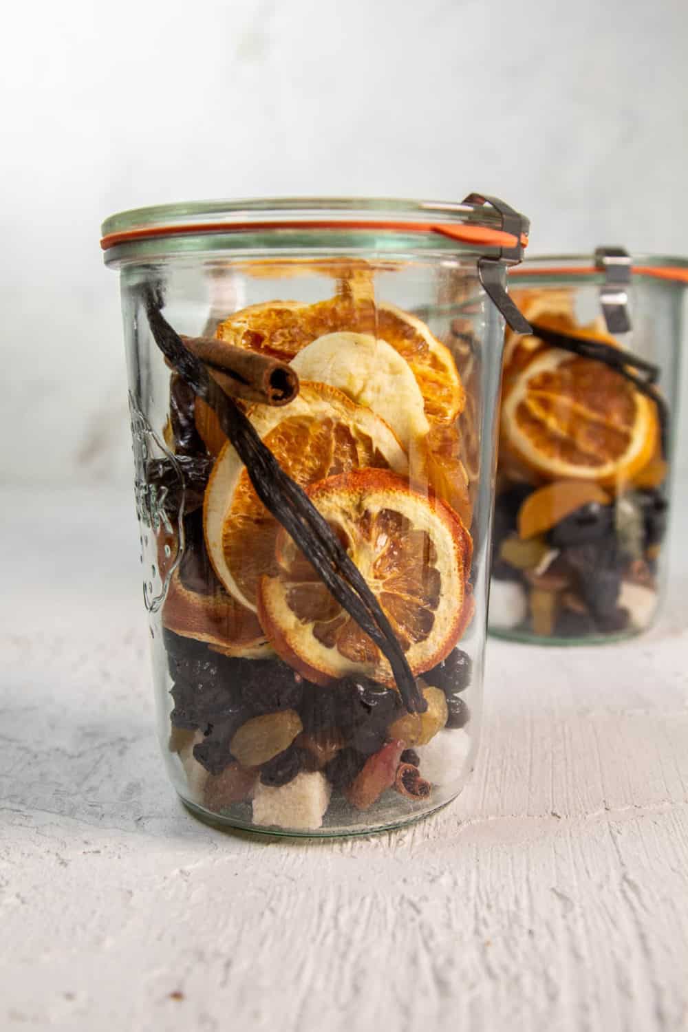A fruitcake cocktail infusion kit with dried fruit, dehydrated orange slices, and sugar cubes. 