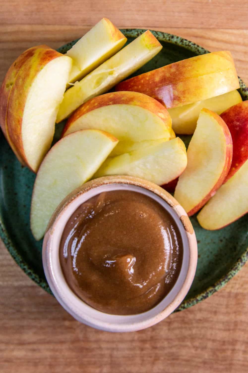 Date caramel in a small bowl with apple slices,