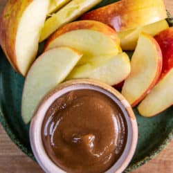 Date caramel in a small bowl with apple slices,