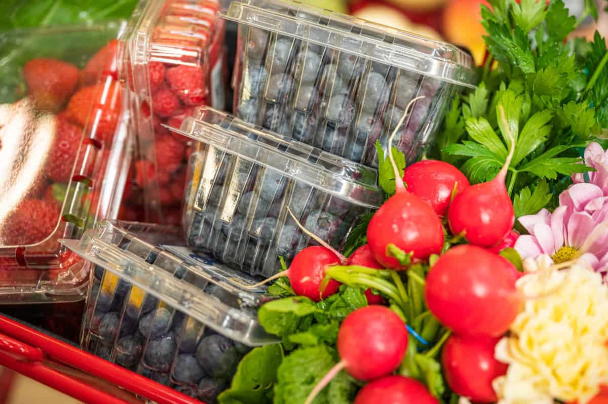 blueberries in a shopping cart at the grocery store