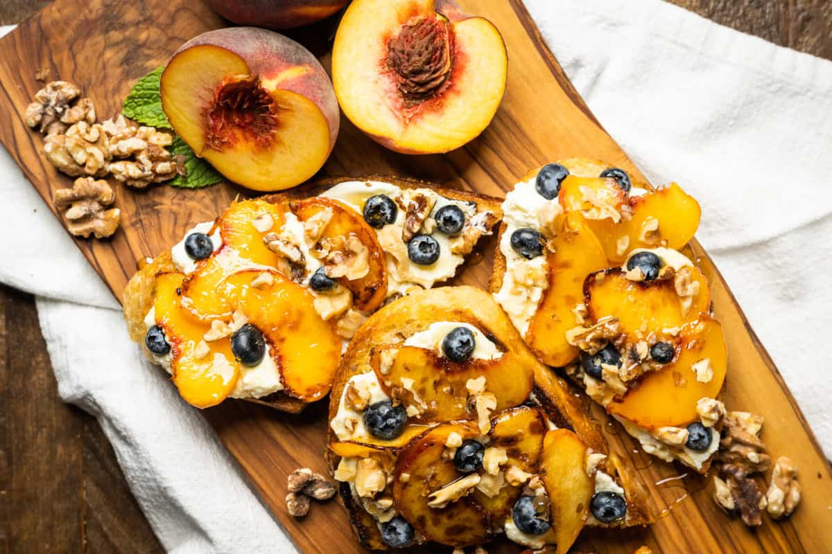 Ricotta Toast with warm peaches, walnuts and blueberries