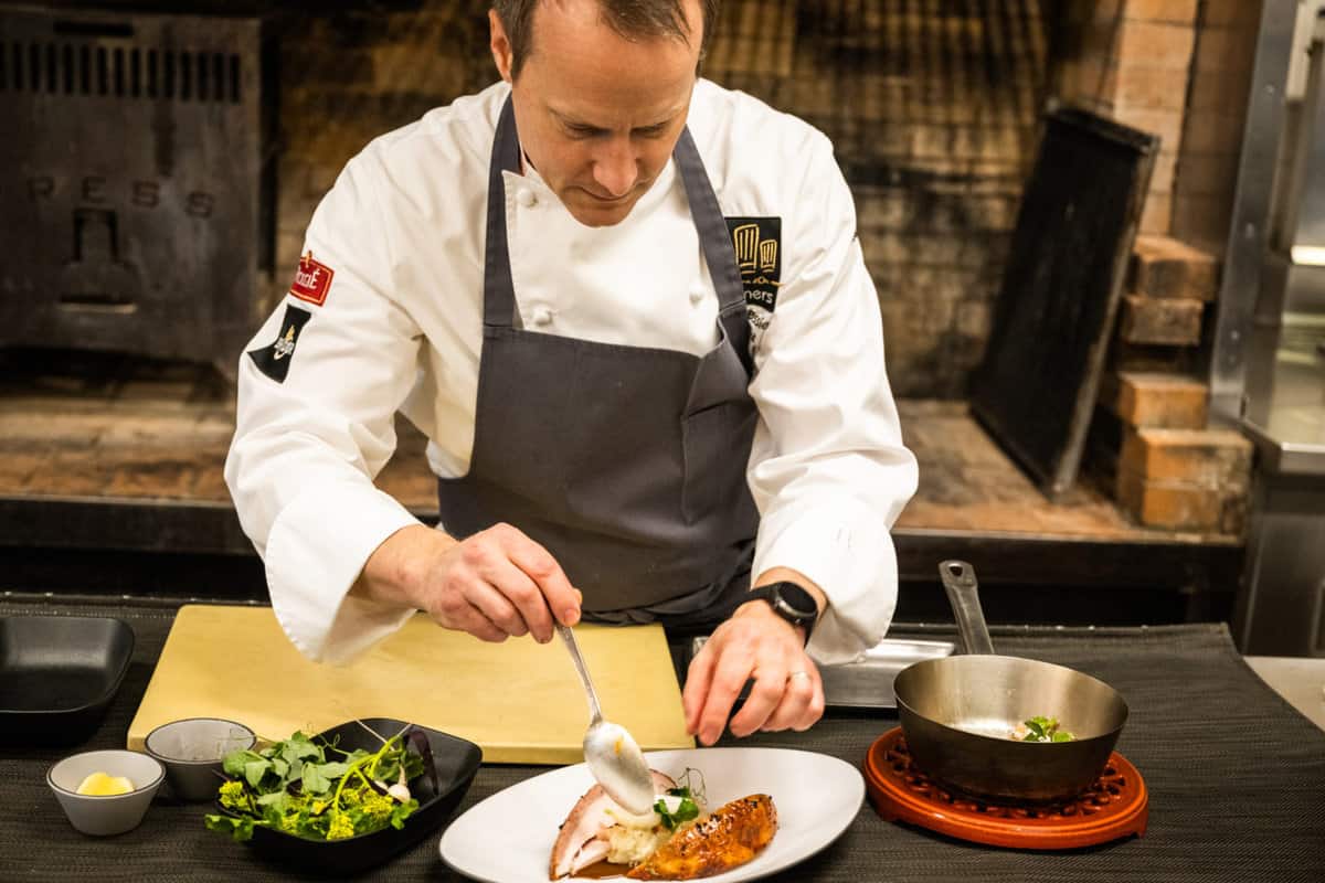 Chef Phillip Tessier of PRESS restaurant preparing a dish for the daily menu