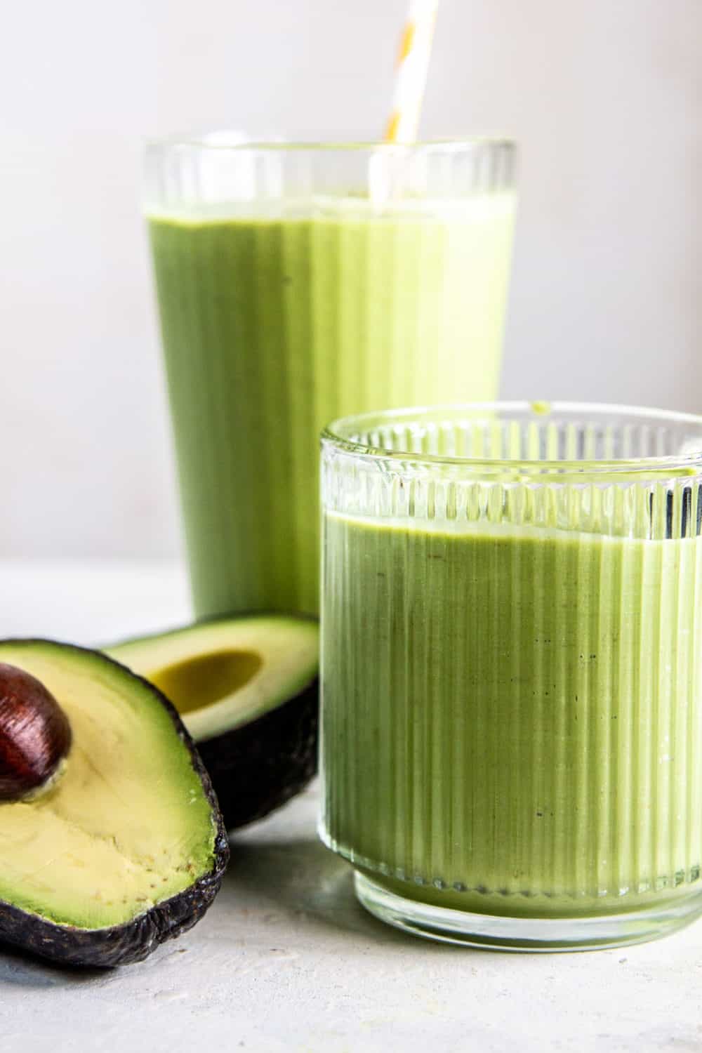 Green Avocado and Honey Smoothie in two glasses.