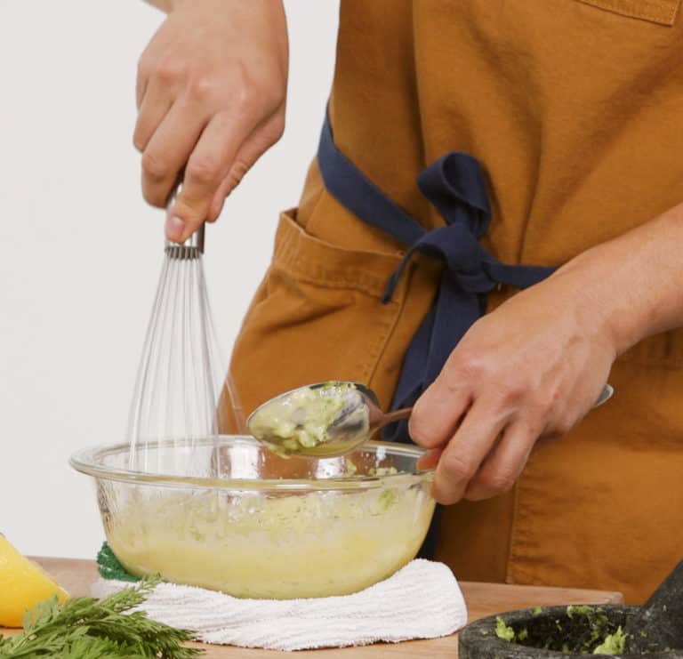 whisking homemade aioli sauce