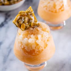 Small glasses of cantaloupe granita with pistachio brittle.