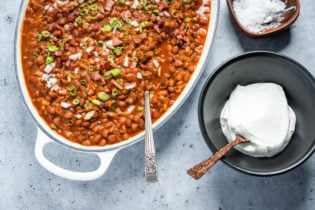 Santa Maria-Style Beans with sour cream and garnishes