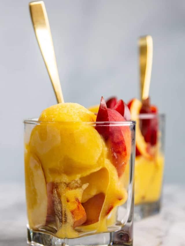 Cups of peach sorbet with slices of stone fruit.