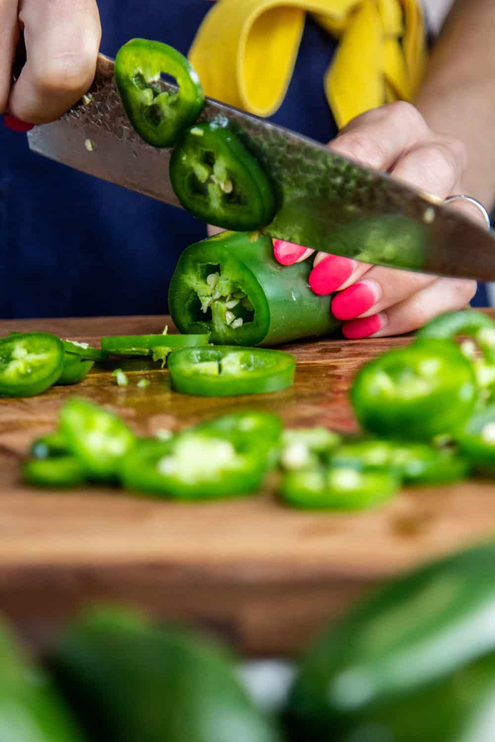 Slicing jalapenos.