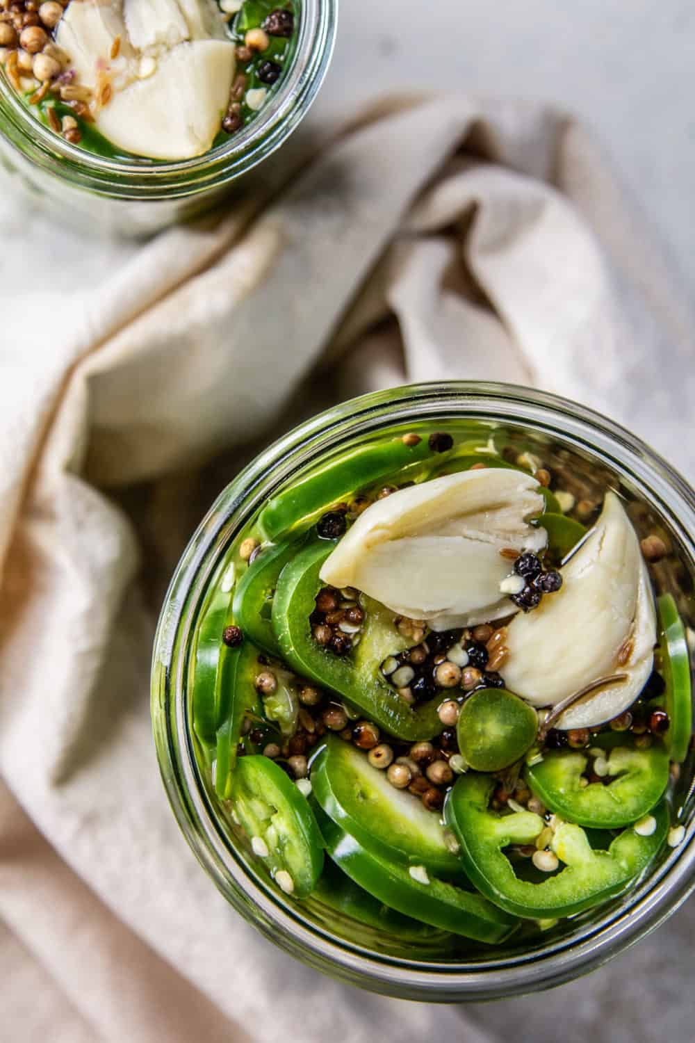 Top down looking into a jar of pickled jalapenos