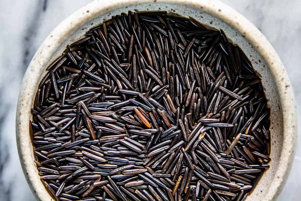 A bowl of uncooked wild rice.