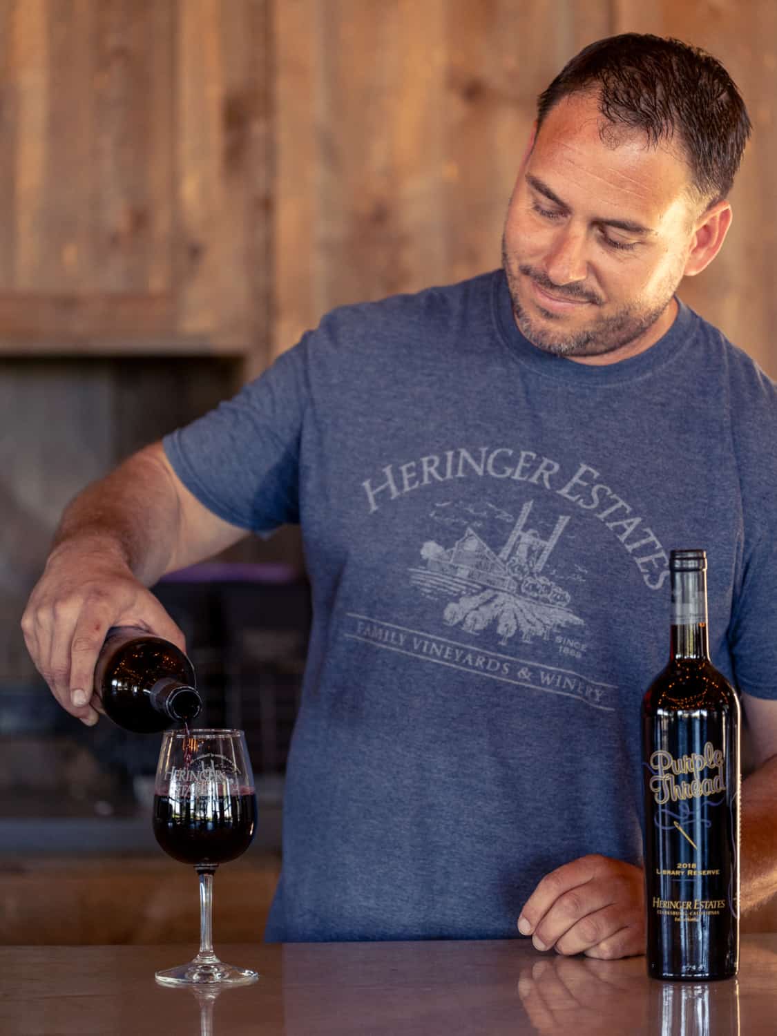 Mike Heringer pouring a glass of Purple Thread in his Clarksburg tasting room