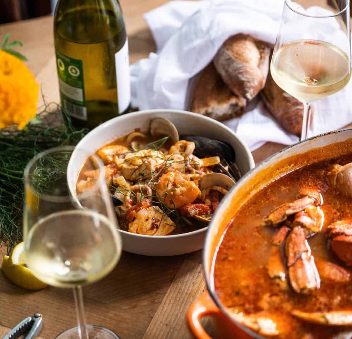 Cioppino served over Linguine pasta | paired with Chardonnay and Dolcetto | seafood pasta |   Cioppino is a fish stew originating in San Francisco Bay Area of California. It is an Italian-American dish and is related to various regional fish soups and stews of Italian cuisine.

