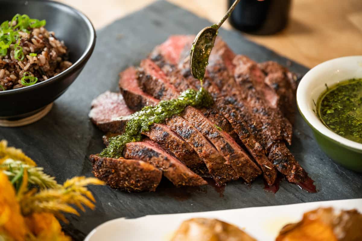 Santa Maria-style Tri Tip paired with red wine | Grilled tri tip with fresh herb chimichurri, roasted sweet potatoes and wild rice | paired with Zinfandel and Cabernet Sauvignon