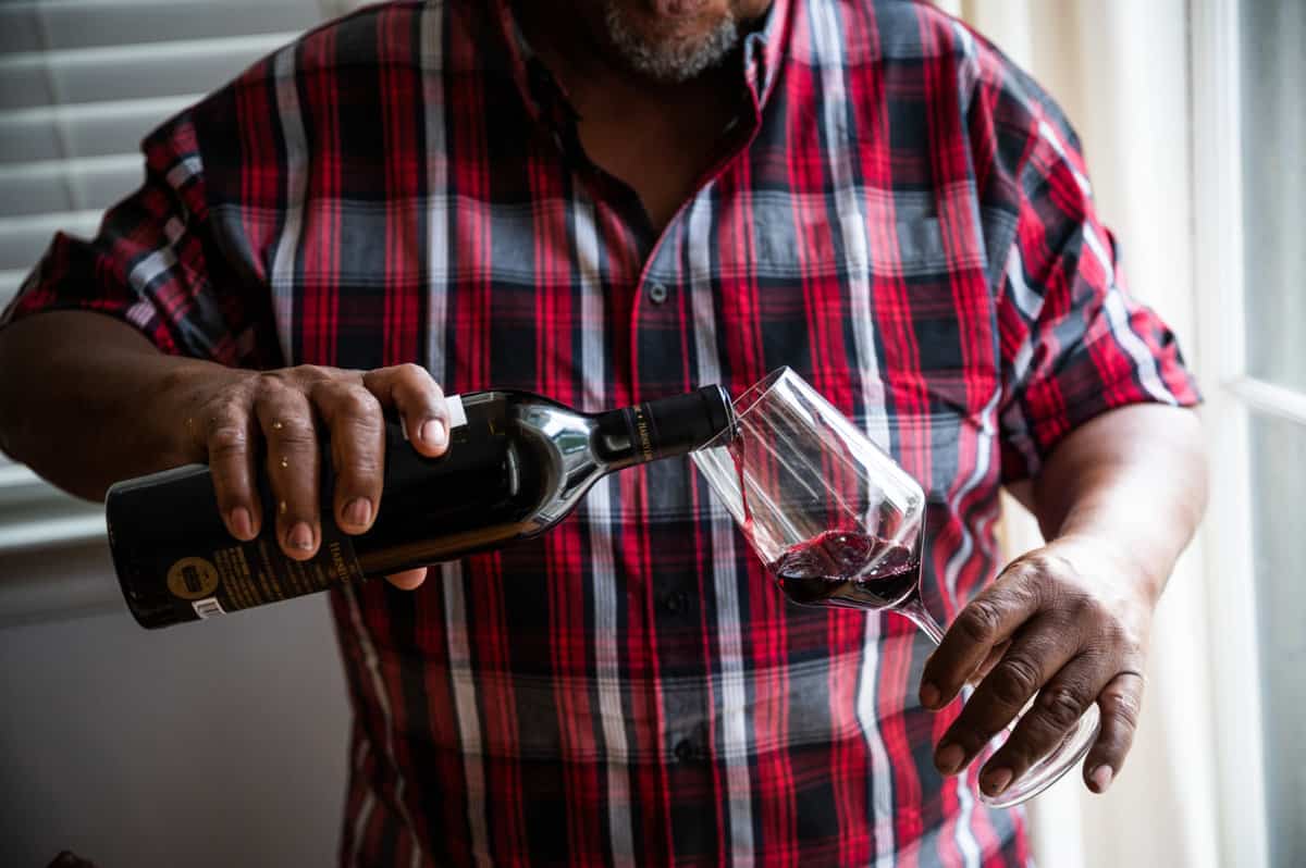 pouring red wine into a stemmed wine glass 
Photo courtesy of james collier for California Wines