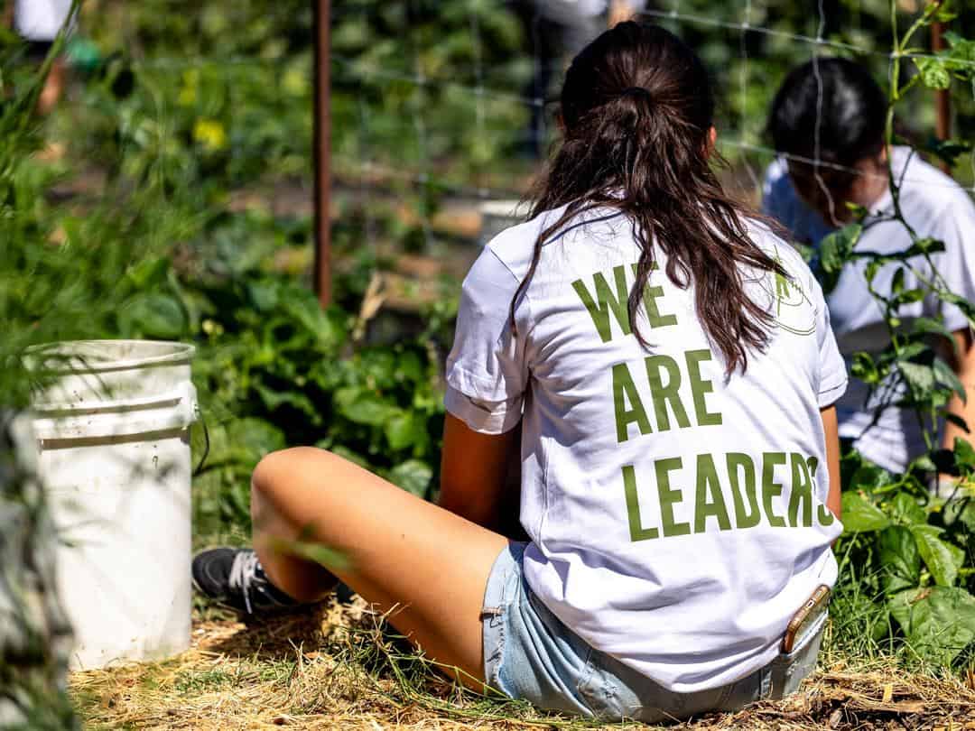 girl planting seedlings at Three Sisters Gardens