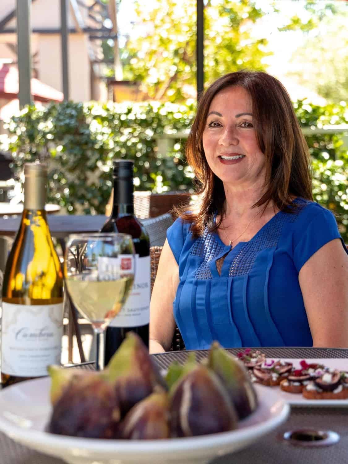 Liz Mishler sitting at one of Bella Bru's outdoor patio tables