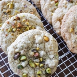 Pistachio white chocolate chip cookies on a cooling rack
