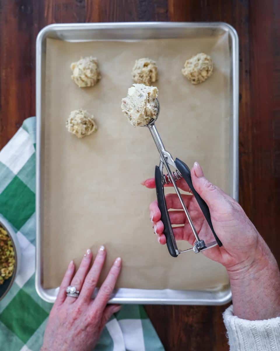 scooping cookie dough onto baking sheet
