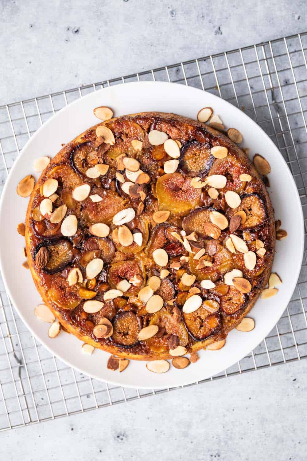 Almond-Fig Upside Down Lemon-Olive Oil Cake on a cooling rack,