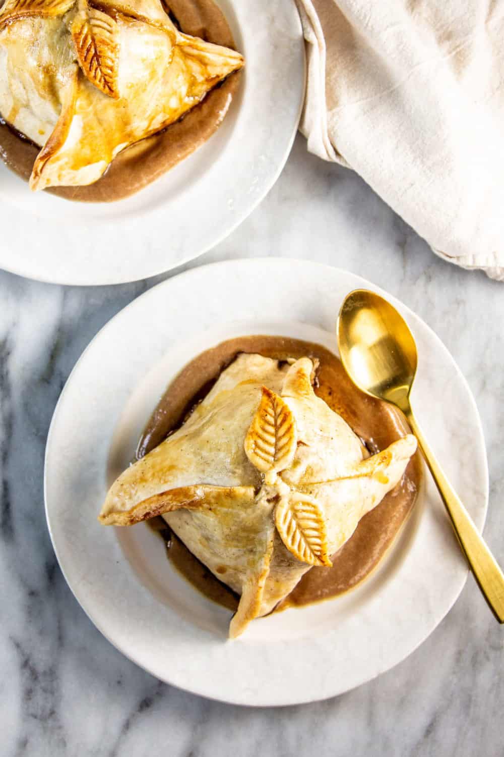 Finished apple dumplings plated on date caramel.