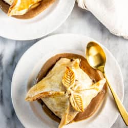 Finished apple dumplings plated on date caramel.