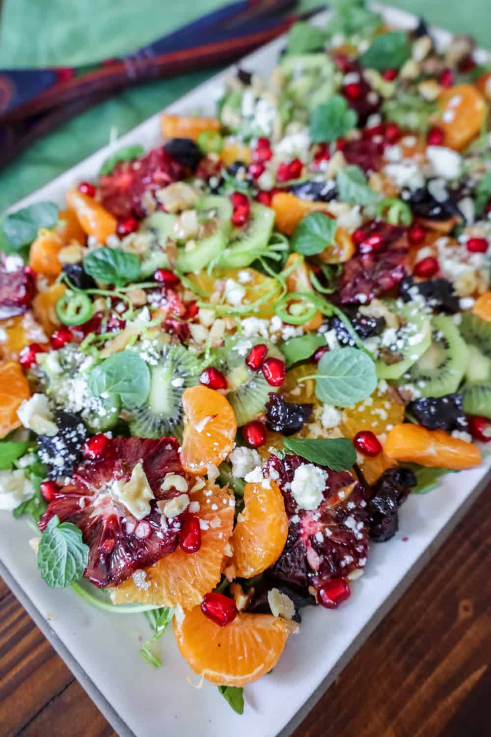 winter fruit salad displayed on a white platter with a green napkin