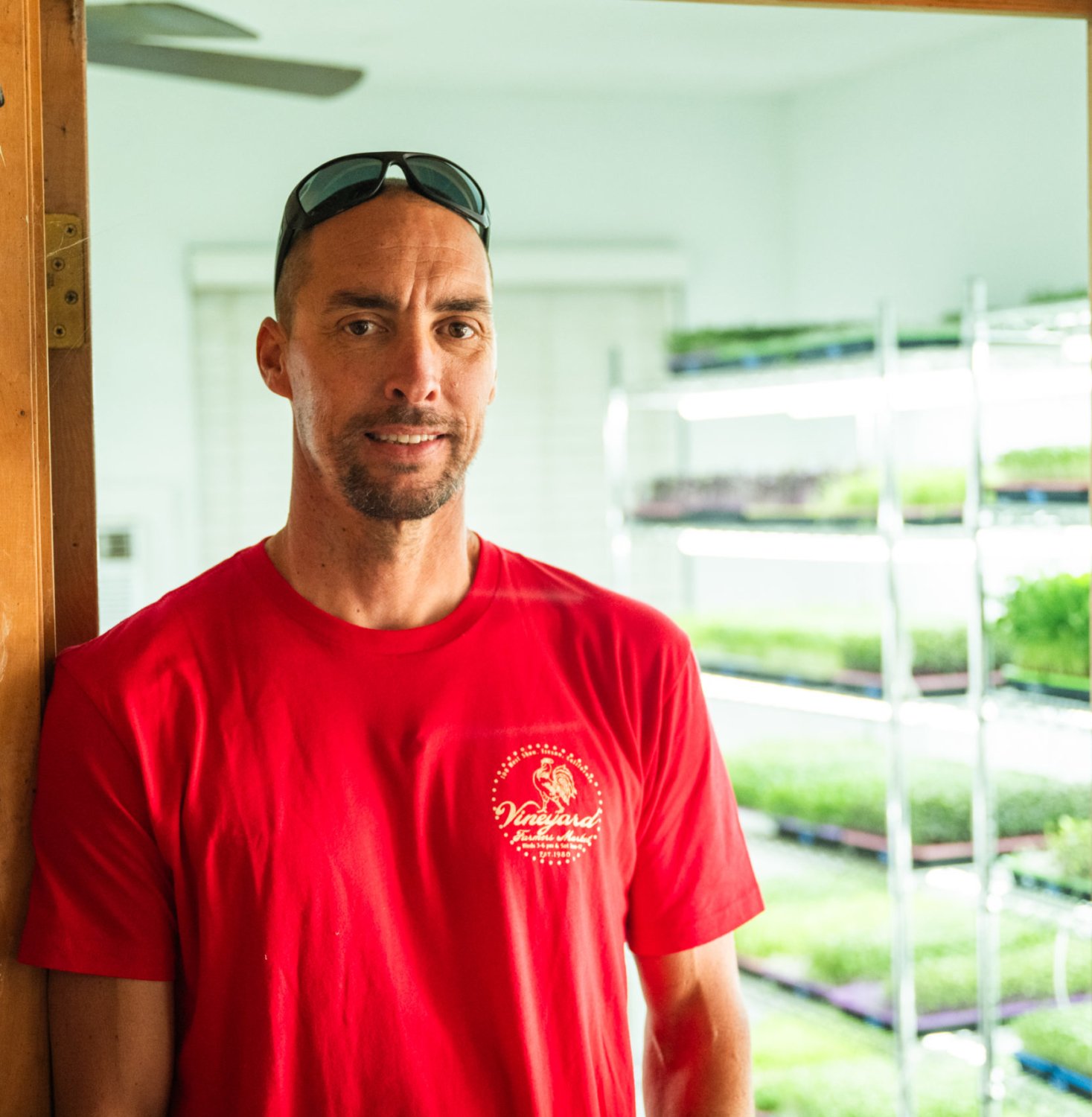 Gianni Raines Zone Nine Microgreens, standing in front of his grow room