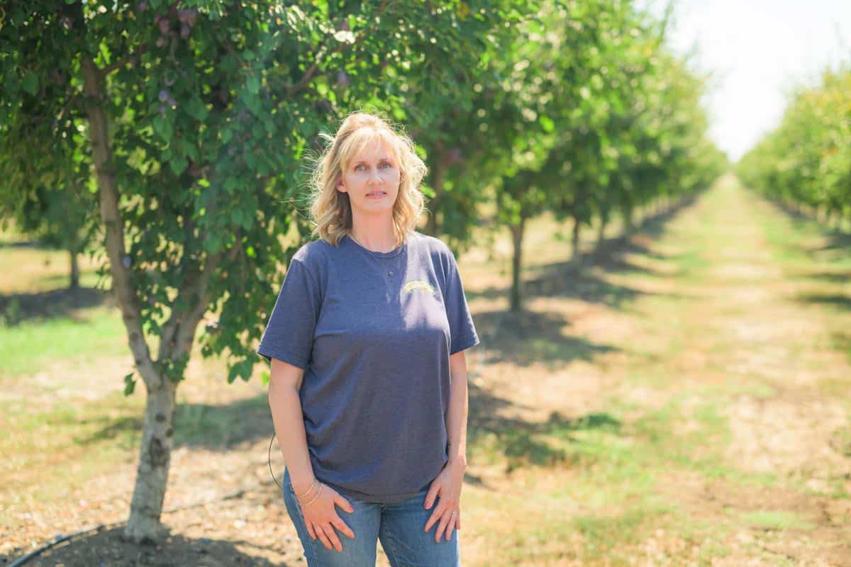 Woman standing in orchard