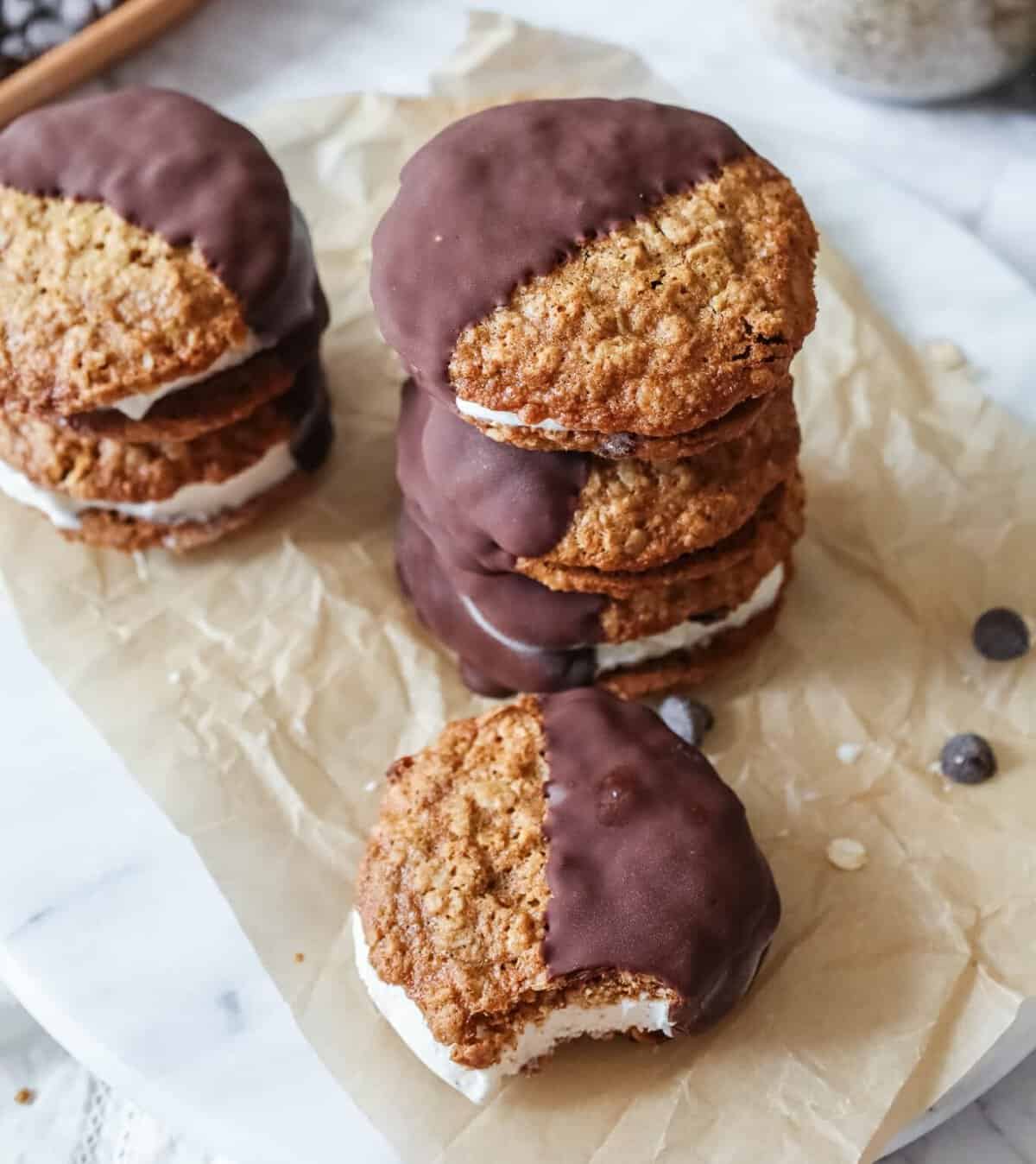 five copycat “IT’S-IT” ice cram sandwiches with oatmeal raisin cookies one with a bite out, from A Girl Defloured