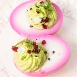 The Most Beautiful Pickled Beet & Avocado Deviled Eggs on a serving plate.