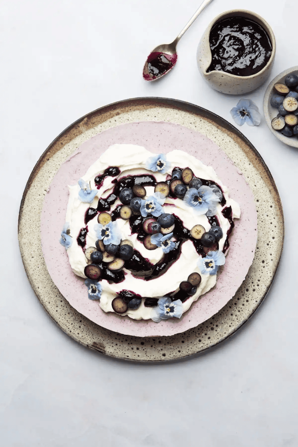 No bake blueberry cheesecake topped with blueberries, compote and whipped cream
