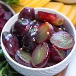 A bowl of purple pickled grapes.