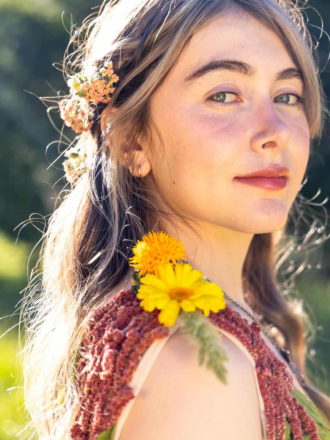 girl with flowers in her hair and a dress made of flowers