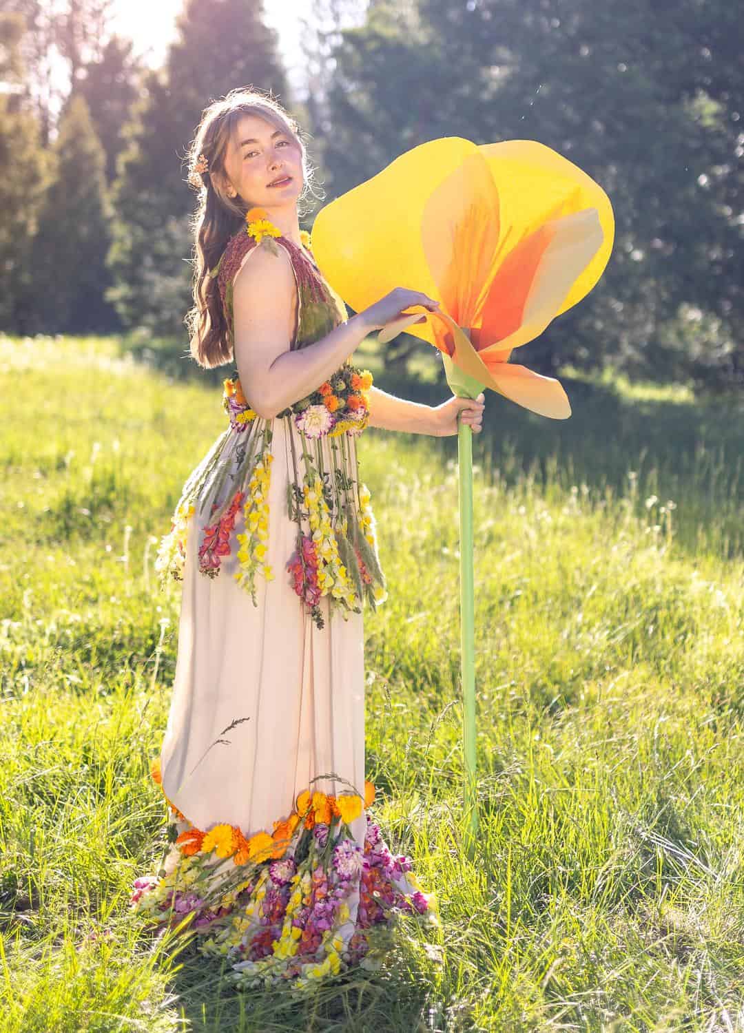 Girl in a dress with an oversized poppy - California's state flower