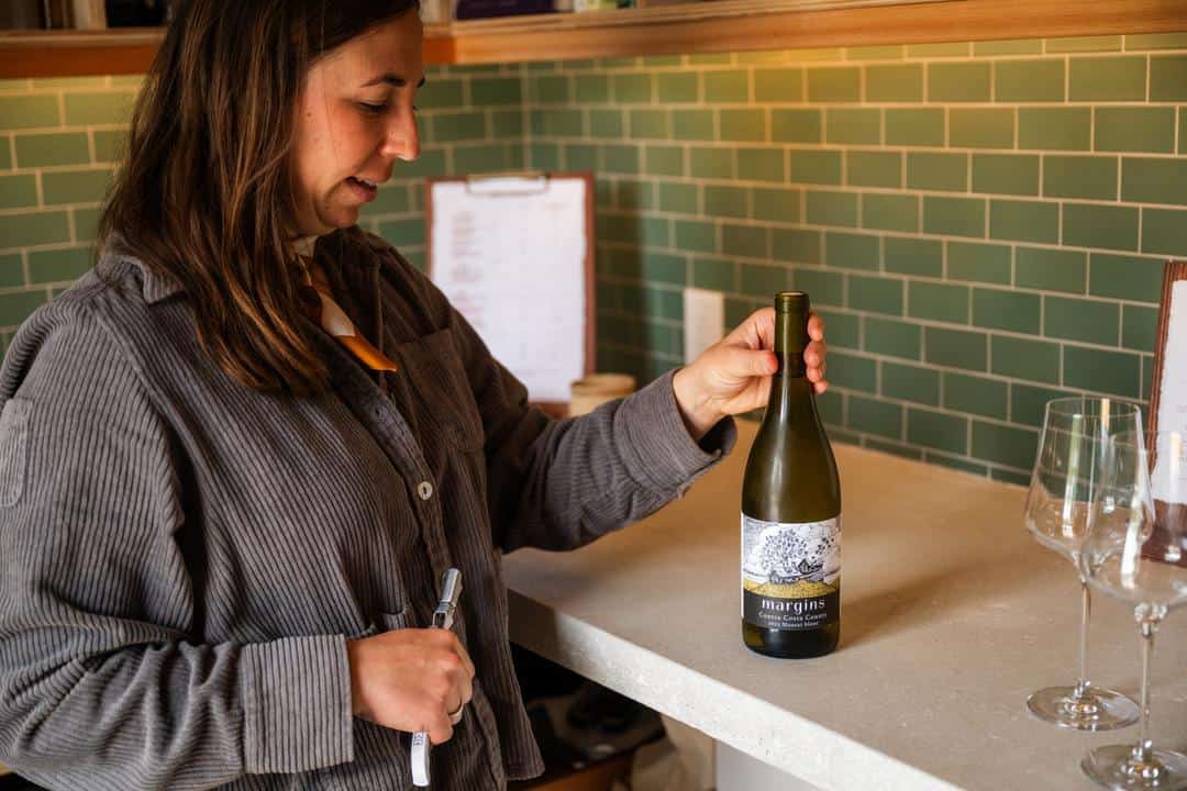 Margins Wine owner Megan Bell opening a bottle of her natural wine