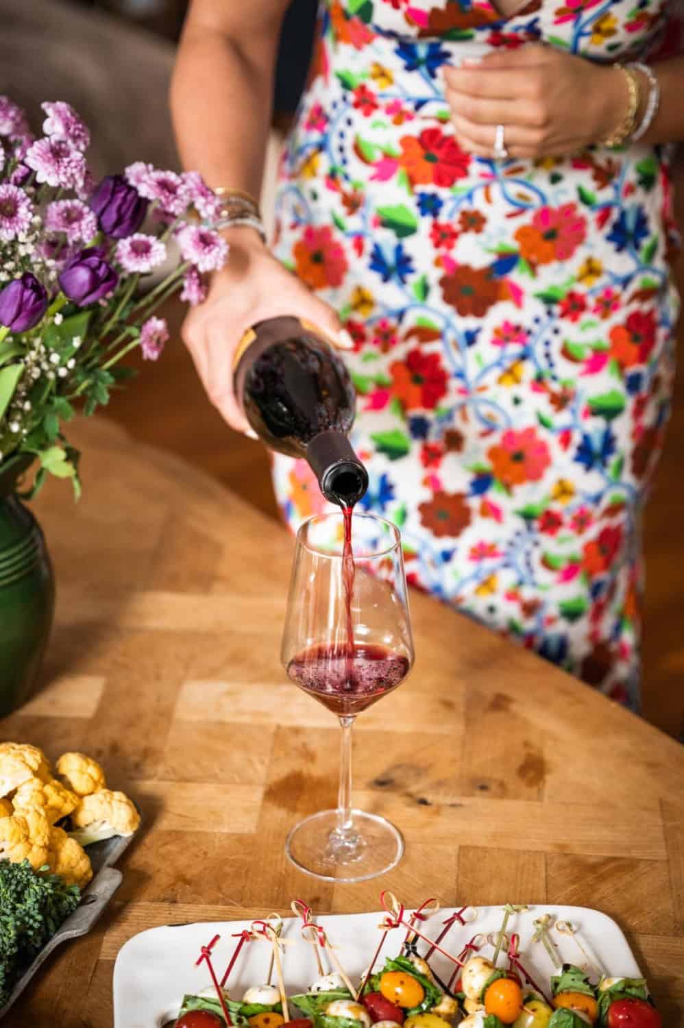 woman pouring a glass of red wine