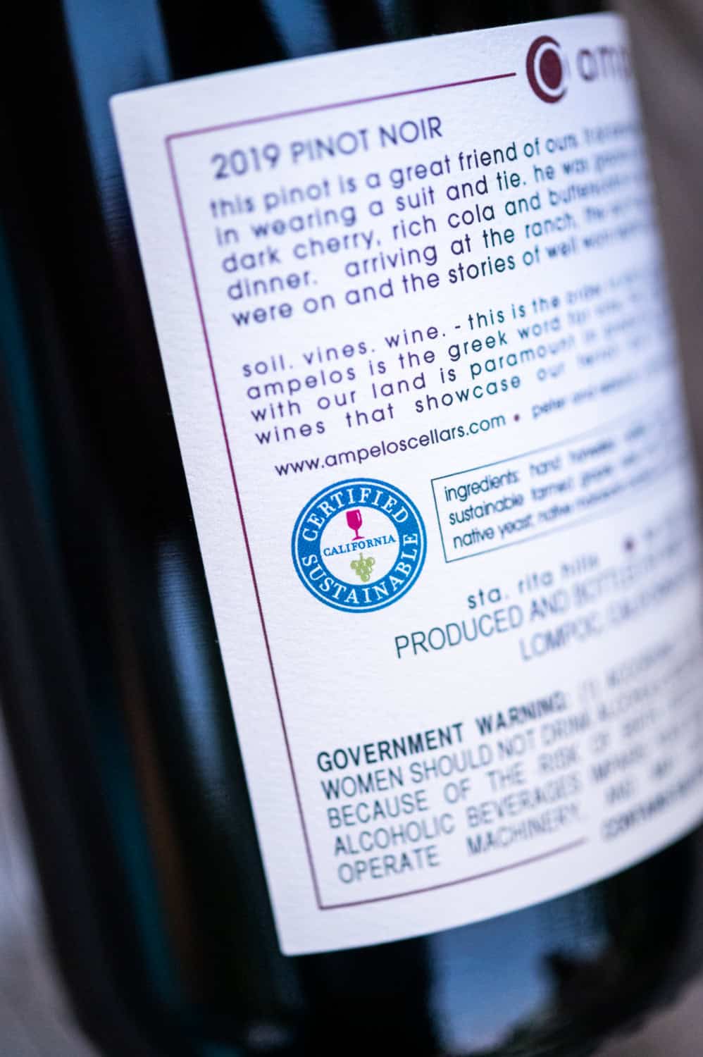 bottle of certified sustainable wine with a visible logo