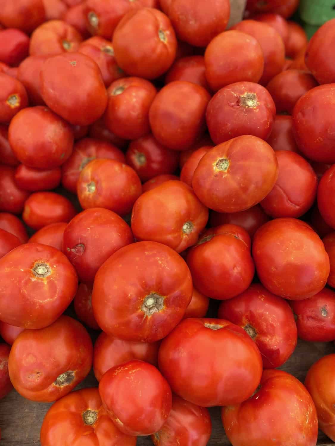 a stack of red ripe tomatoes