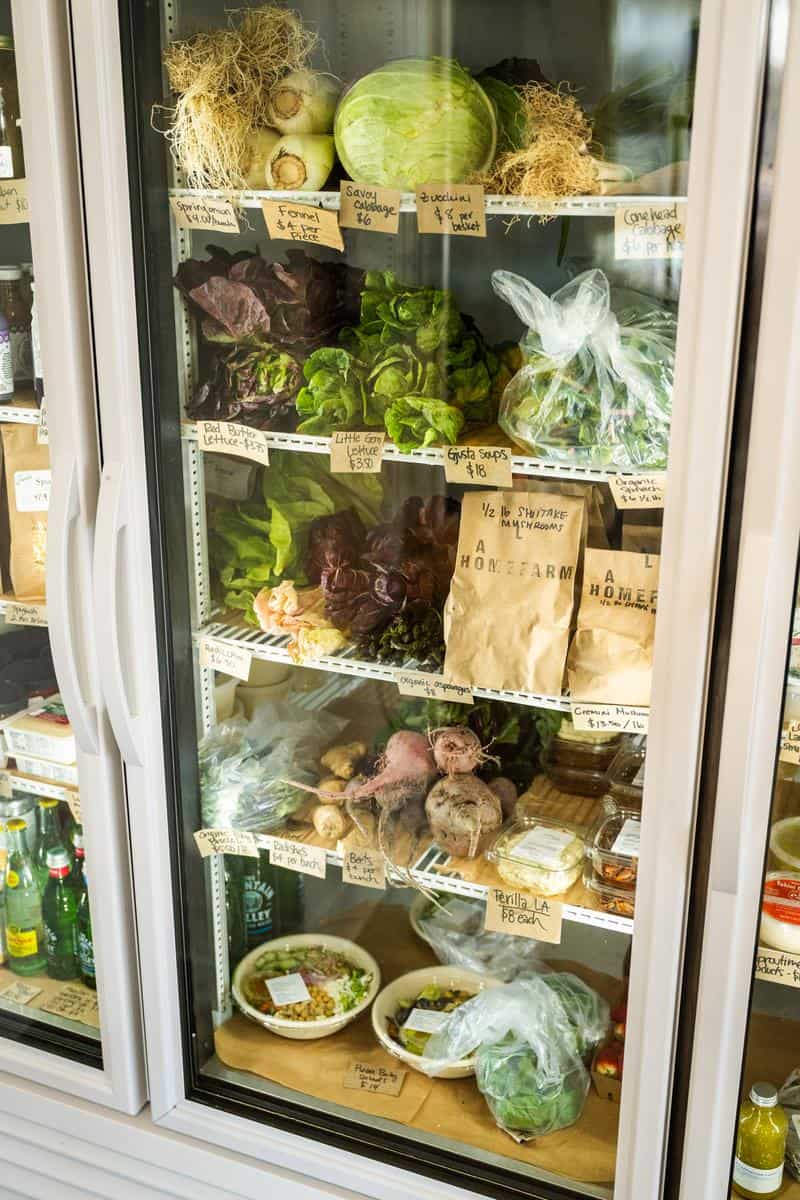 refrigerated produce on shelves in LA Home Farm's shop