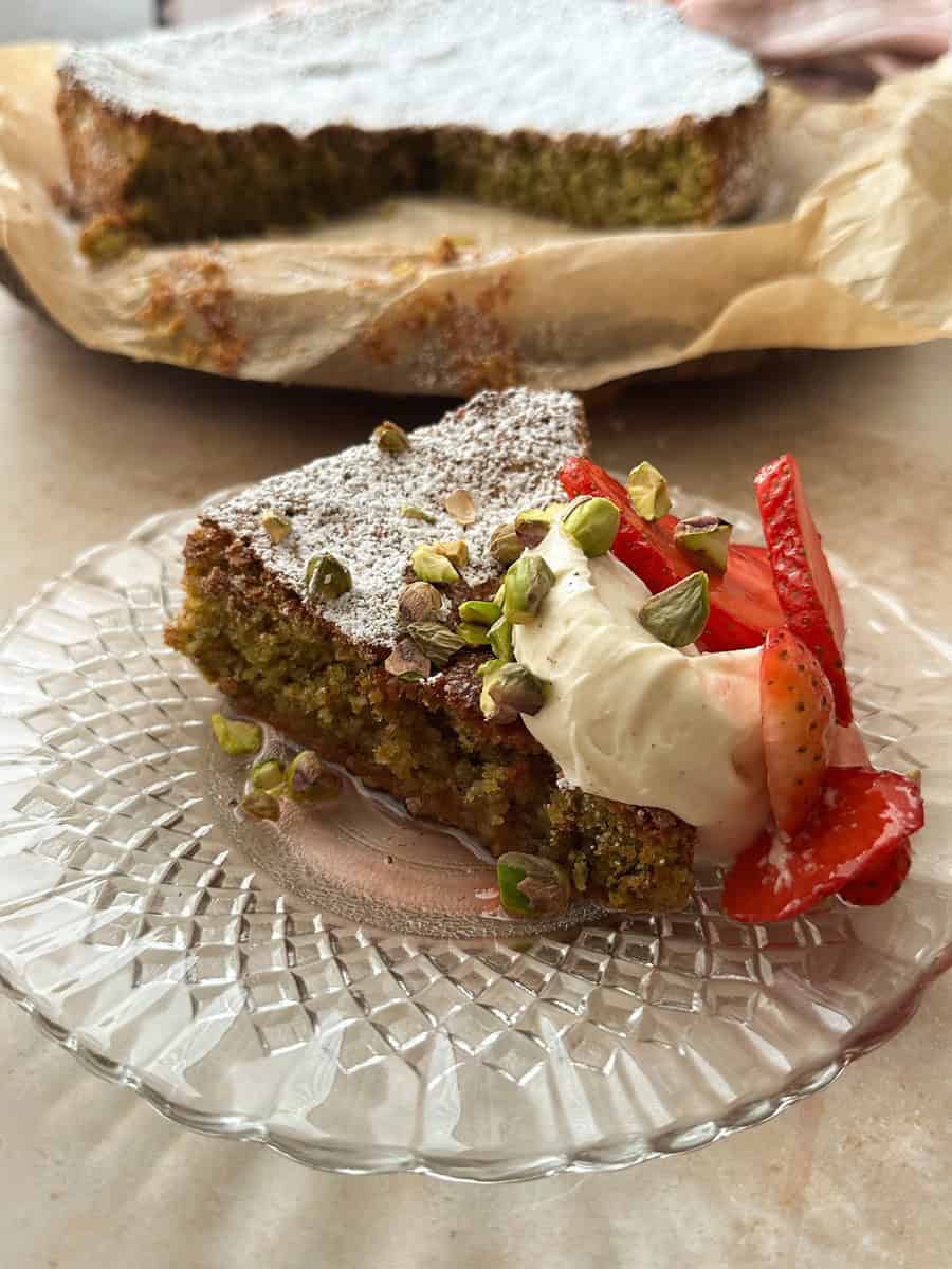 pistachio cake with macerated strawberries and whipped mascarpone cream