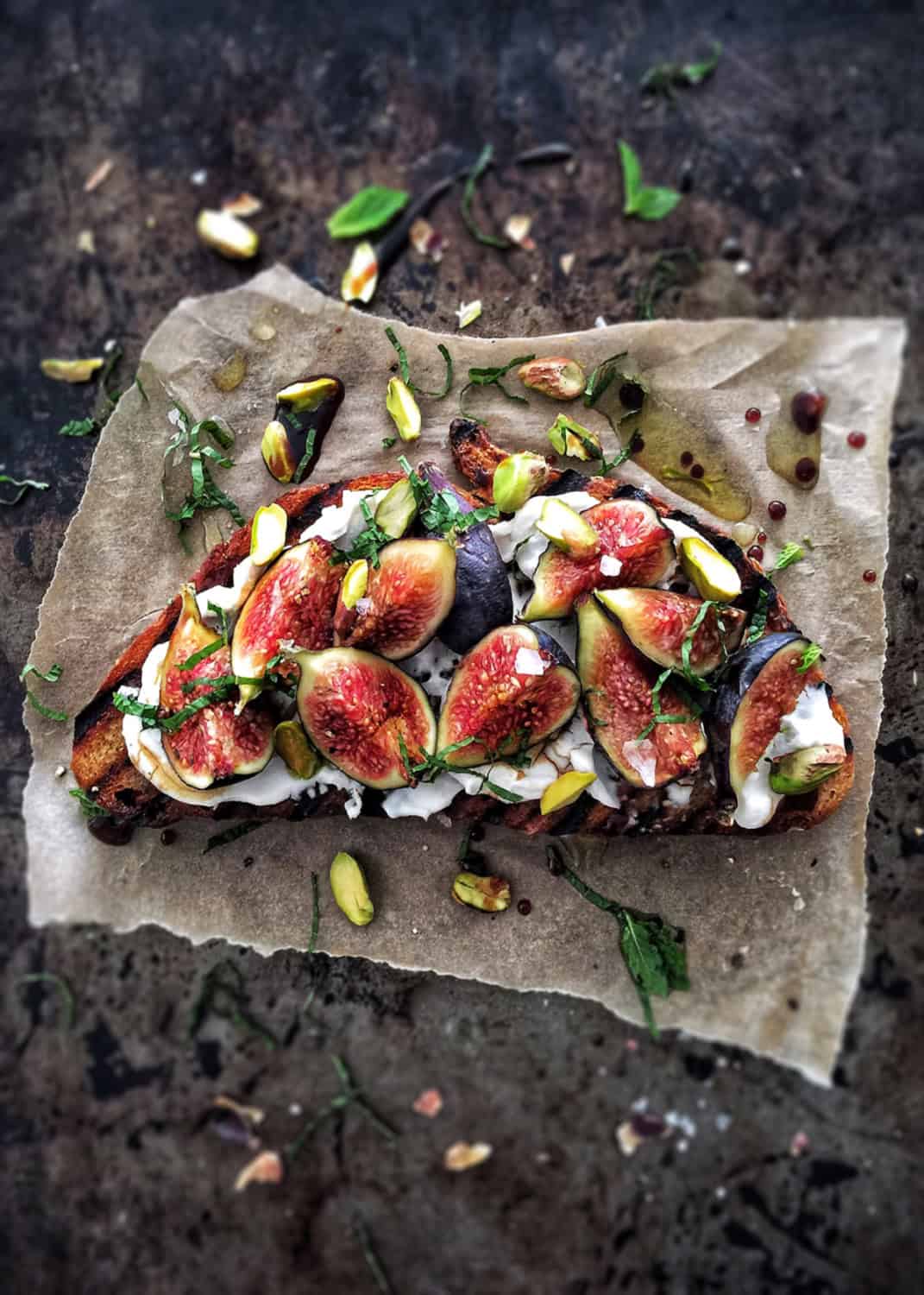 fig ricotta toast on a sheet of parchment