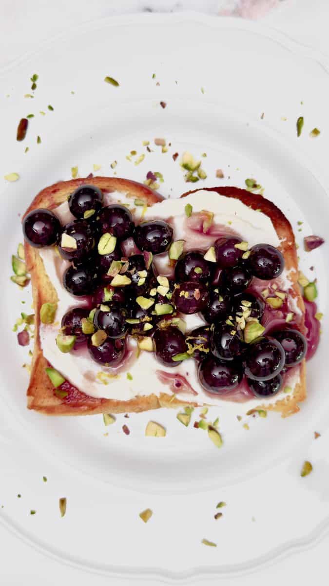 blueberry ricotta toast sprinkled with pistachios