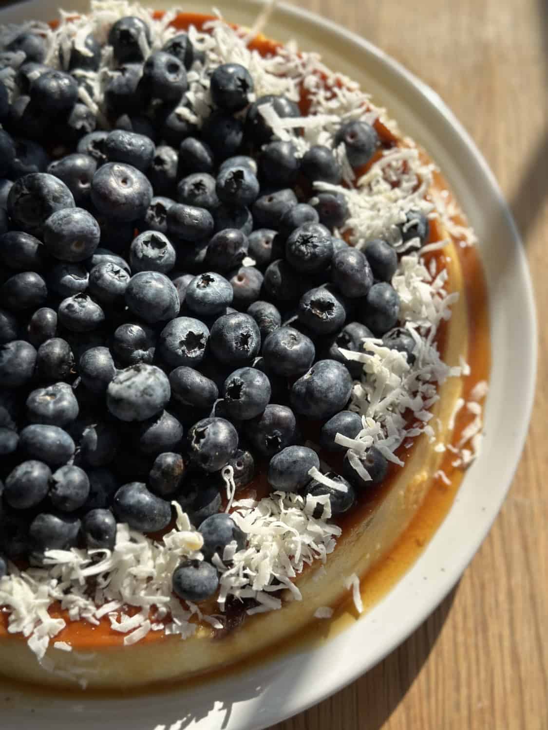coconut flan topped with fresh blueberries