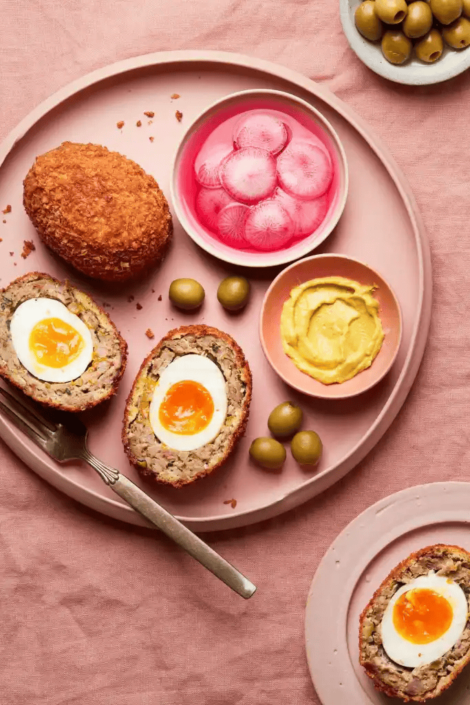 Scotch eggs on a pink plate