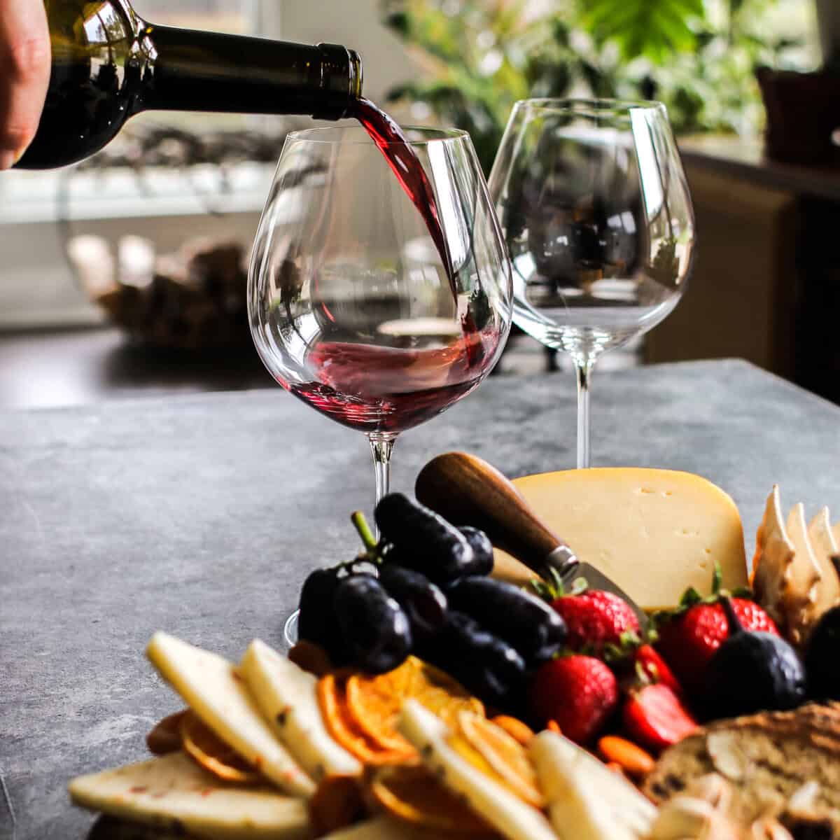 pouring zinfandel into a stemless glass