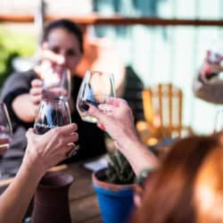 women toasting with wine at desperado in tin city
