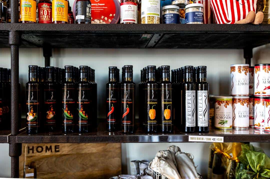 bottles of olive oil lined up on the shelf at the CaliVirgin tasting room